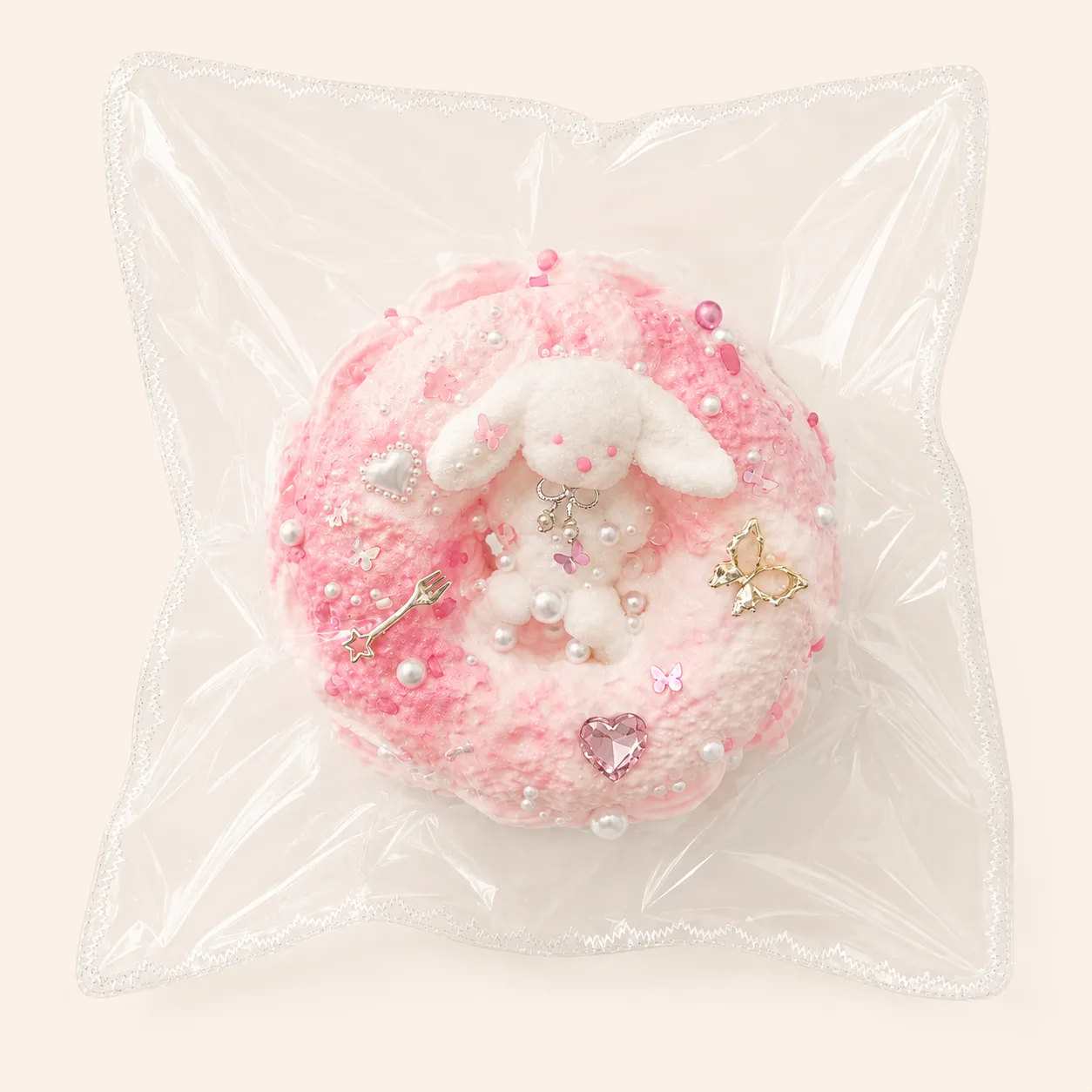 Juguete blando de conejo con forma de donut rosa
